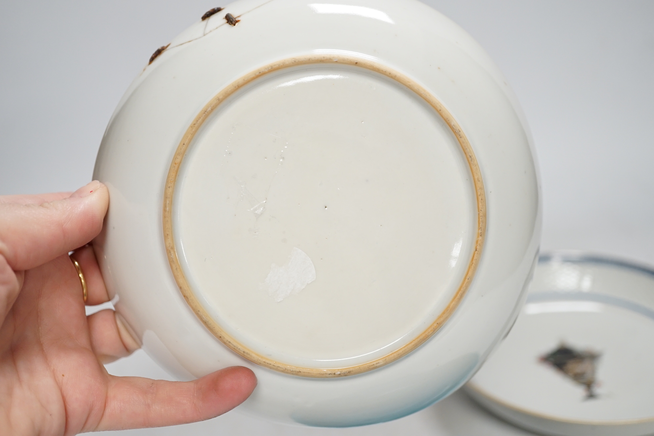 A Chinese turquoise glazed saucer dish, Qianlong Mark and period and two Chinese export famille rose saucers, Qianlong period, 16cm diameter